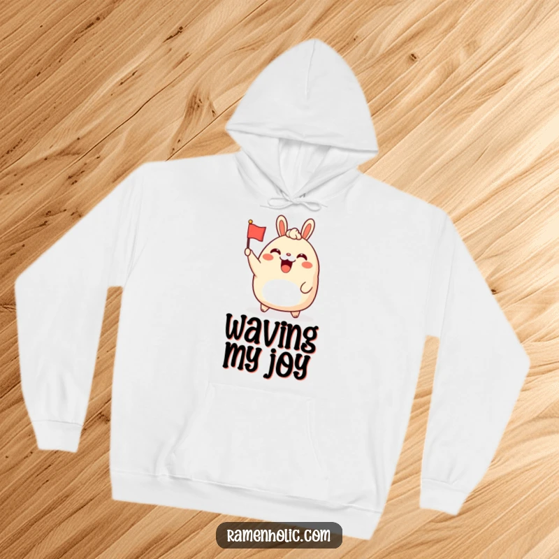 Funny bao bun character hoodie, cheerfully waving a tiny flag, offering warmth and a humorous, celebratory vibe.